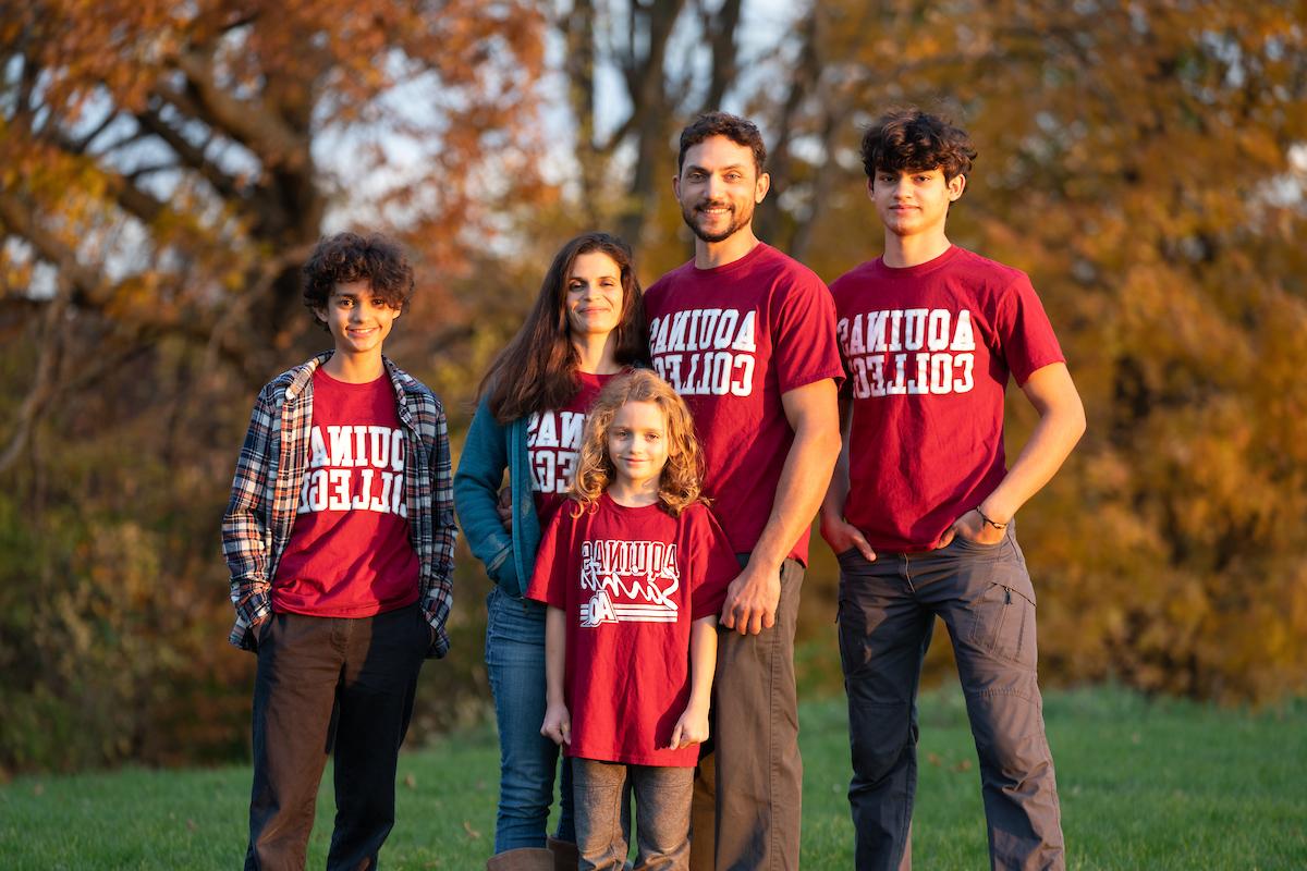Family with three kids in AQ shirts
